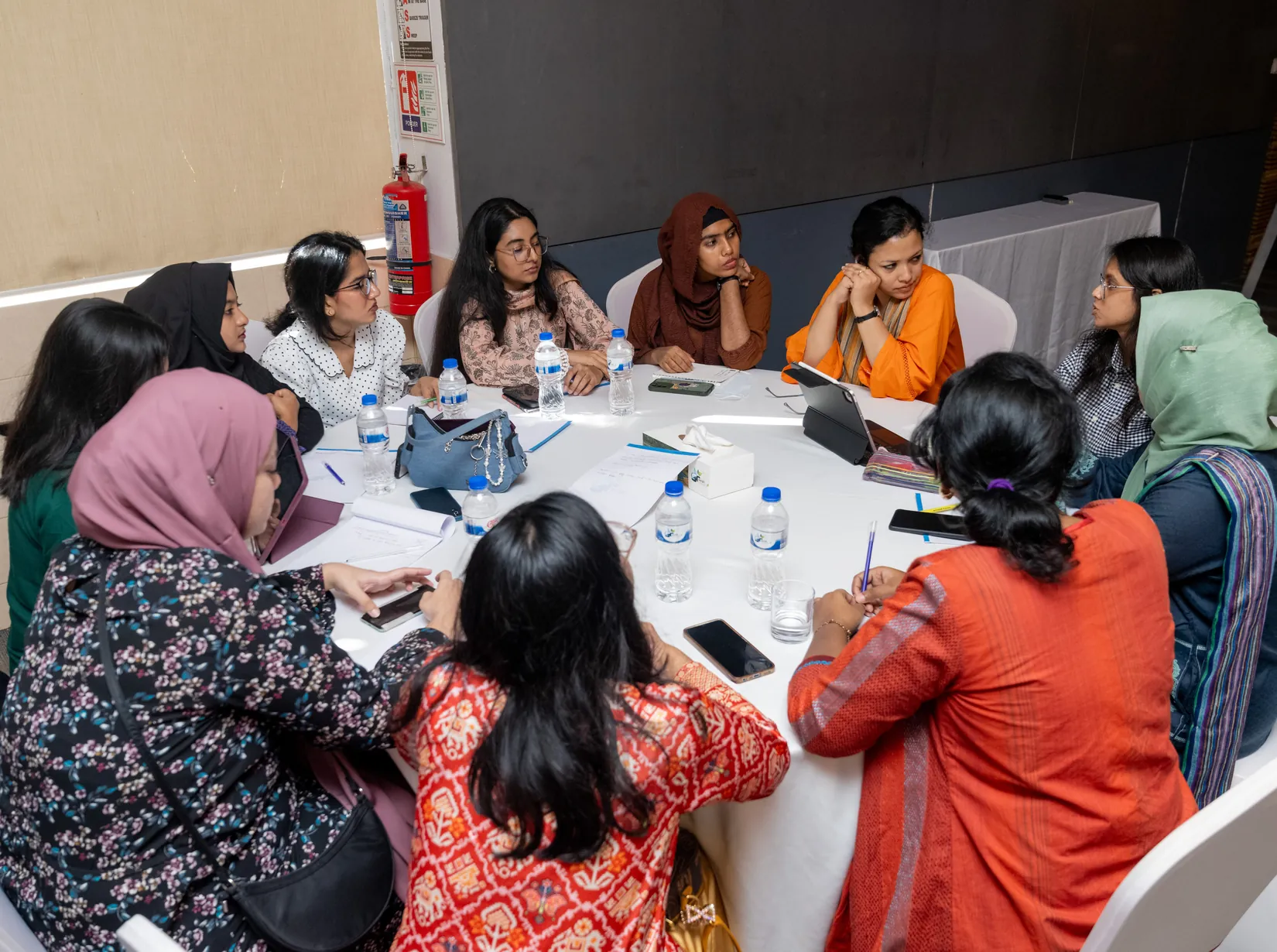 Participants working through an energy challenge around a table