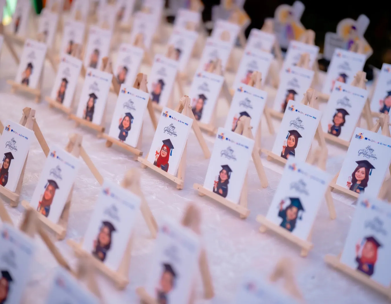 Rows of personalised Happy Graduation caricature cards for each Shoktikonna graduate