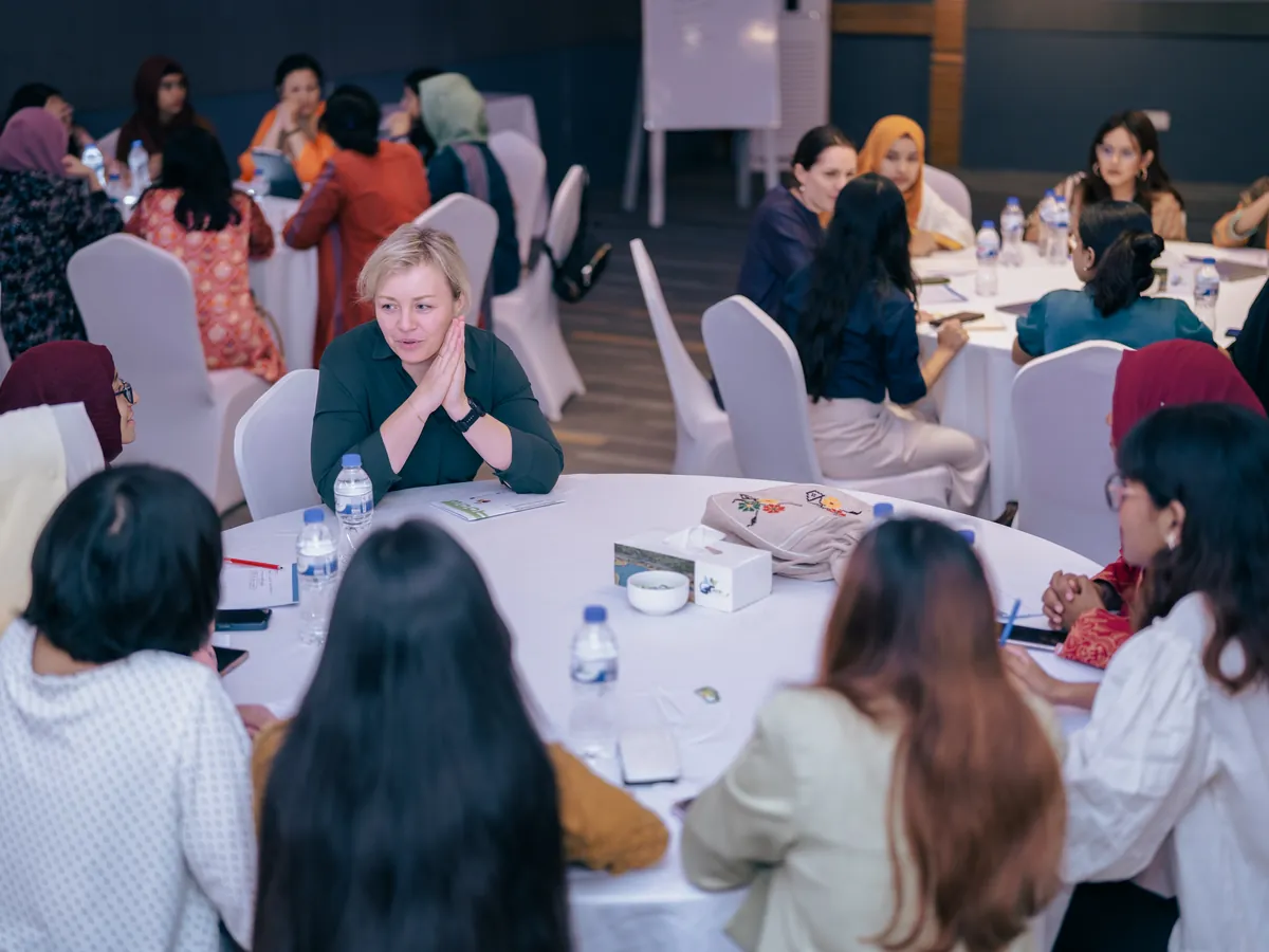 A visiting expert leading a small-group discussion with Shoktikonna participants