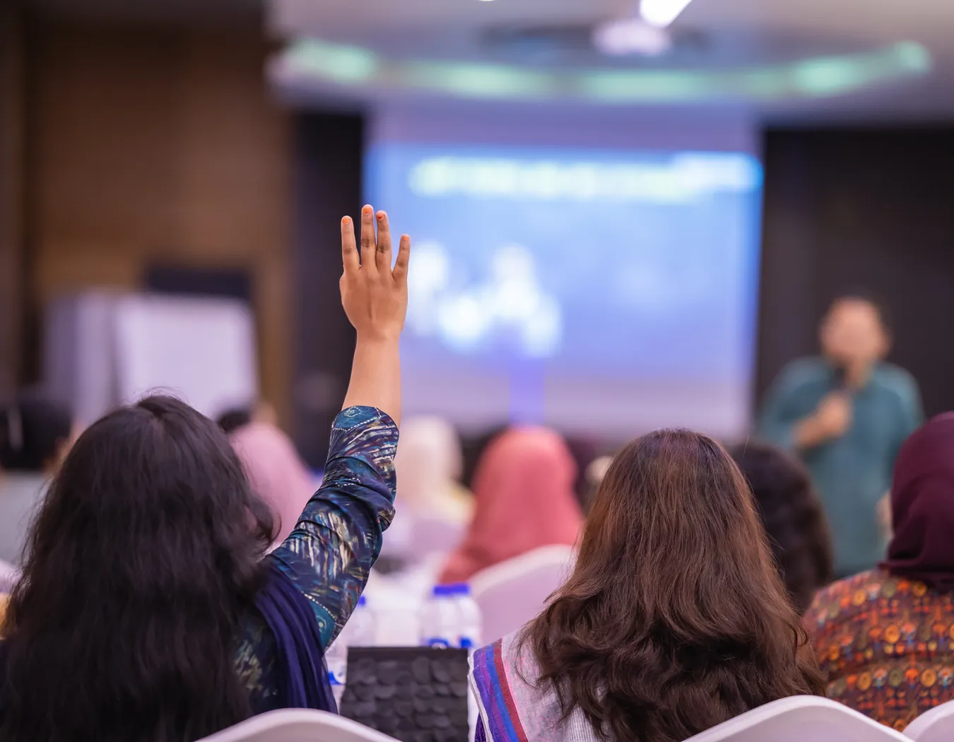 A participant raising her hand to ask a question during a live session