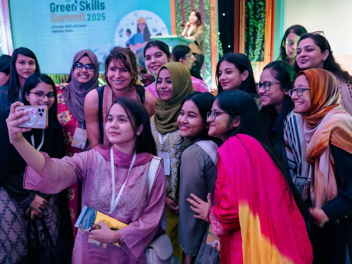 A group of Shoktikonnas taking a selfie with a guest speaker at the Green Skills Summit 2025