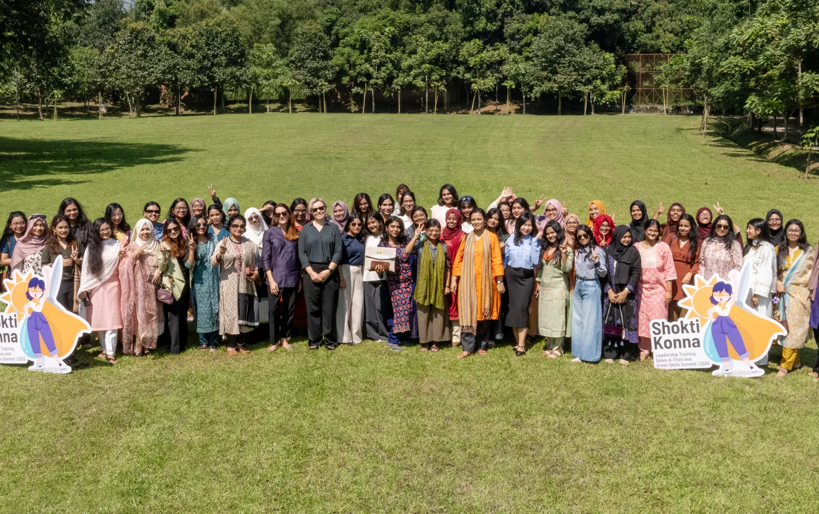 Cohort 3 participants and trainers gathered on the lawn during the Power-Up Bootcamp