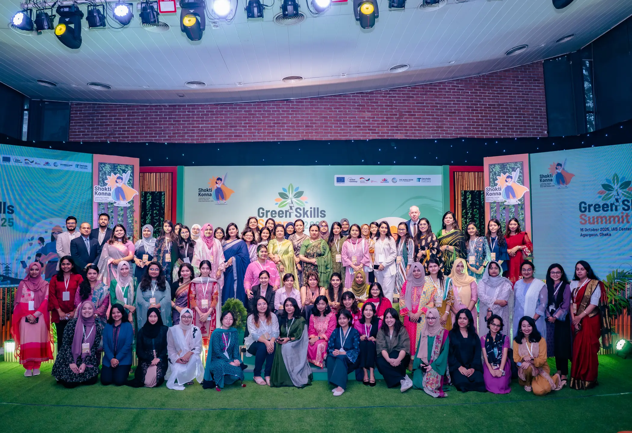 Shoktikonna participants, partners and guests on stage at the Green Skills Summit 2025, IAB Center, Dhaka